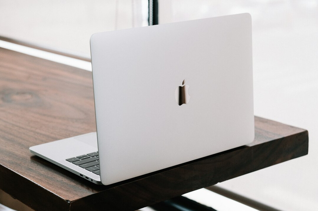Person typing on a laptop with a code editor open
